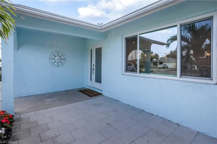Entrance to property featuring a patio area and stucco siding