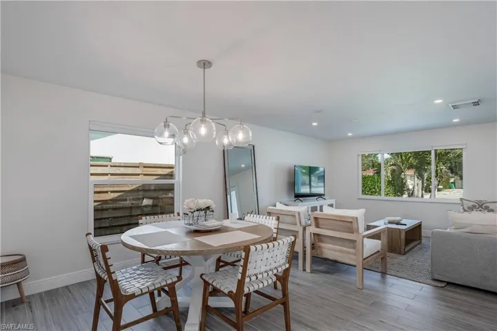 Dining space with recessed lighting, visible vents, baseboards, and wood finished floors