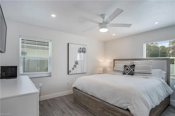 Bedroom featuring ceiling fan, recessed lighting, wood finished floors, and baseboards