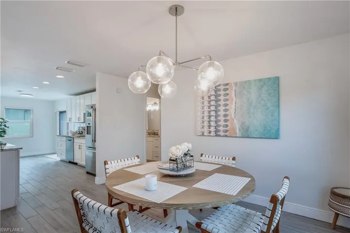 Dining space featuring light wood finished floors, visible vents, and baseboards