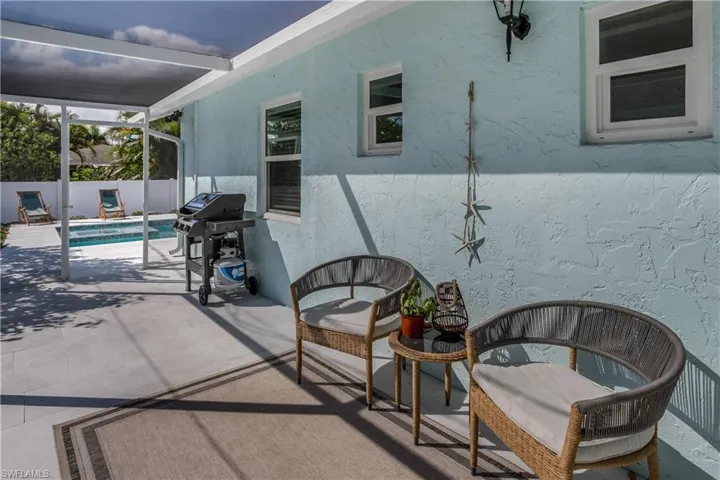 View of patio / terrace featuring area for grilling, fence, a fenced in pool, and a lanai