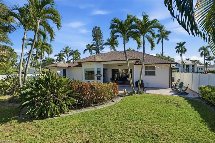 Rear view of house featuring a ceiling fan, stucco siding, and a patio