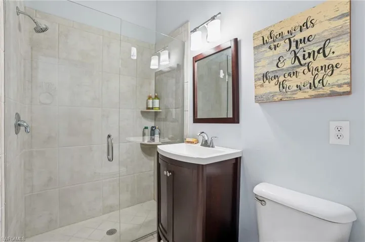 Bathroom featuring vanity and a shower stall