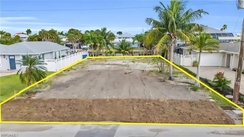 View of parking with a residential view and fence VIRTUALLY EDITED