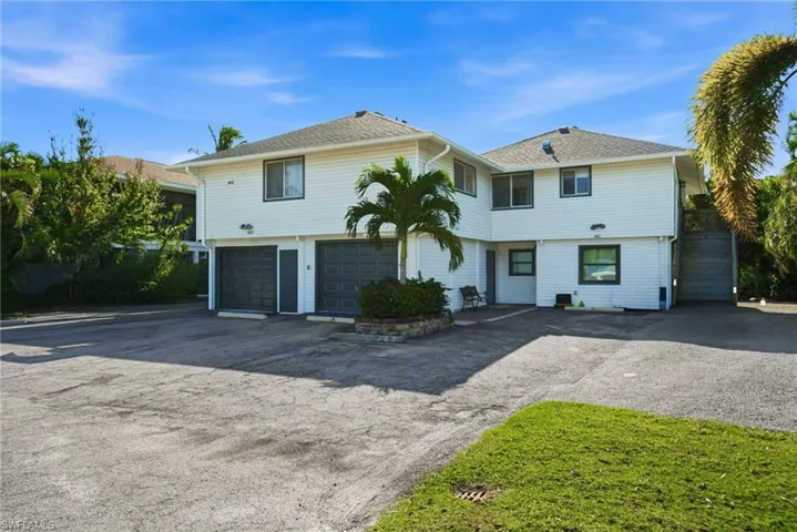 View of front of home featuring driveway and a garage