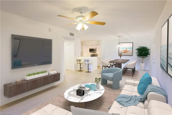 Living room with a textured ceiling, light wood-style flooring, visible vents, and a ceiling fan