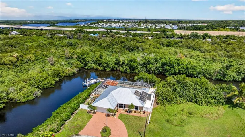 Bird's eye view of a nearby body of water and a tree filled landscape