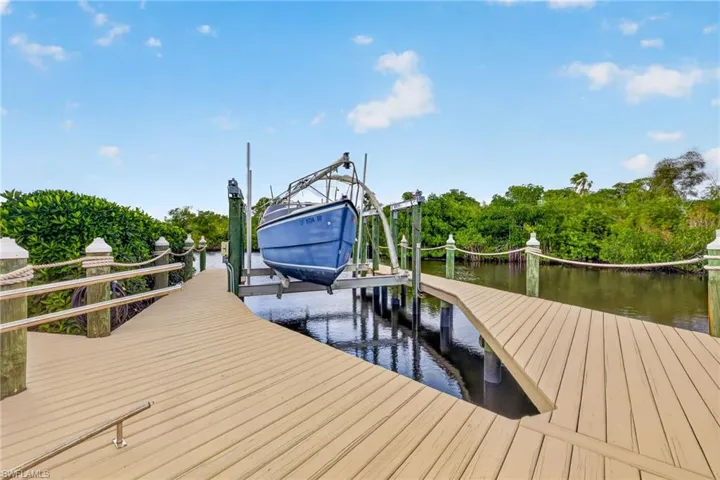 Dock area with boat lift and a water view