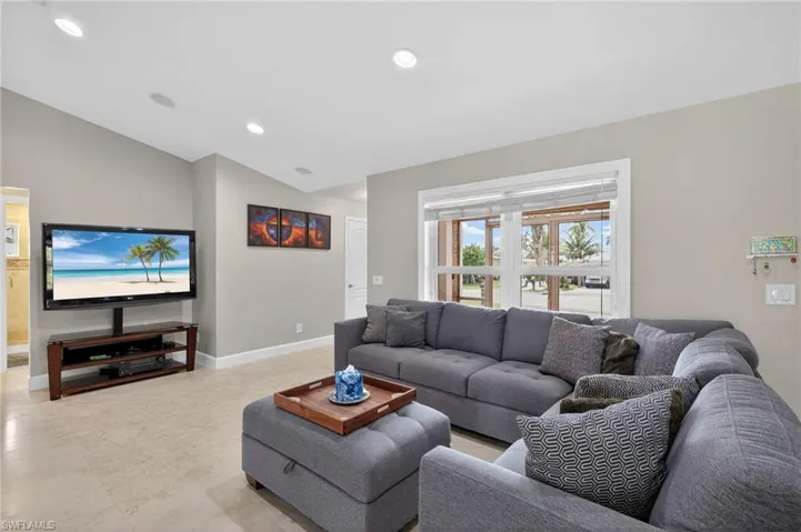 Living area with vaulted ceiling and recessed lighting