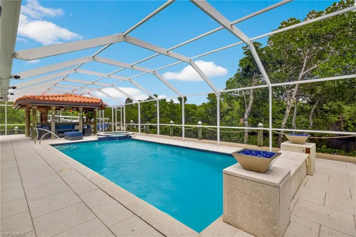 Combined pool / hot tub with a patio area, french doors, a lanai, and a family room/sunroom