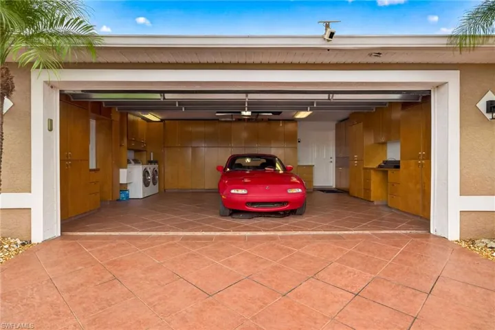 Garage with washer and dryer and driveway