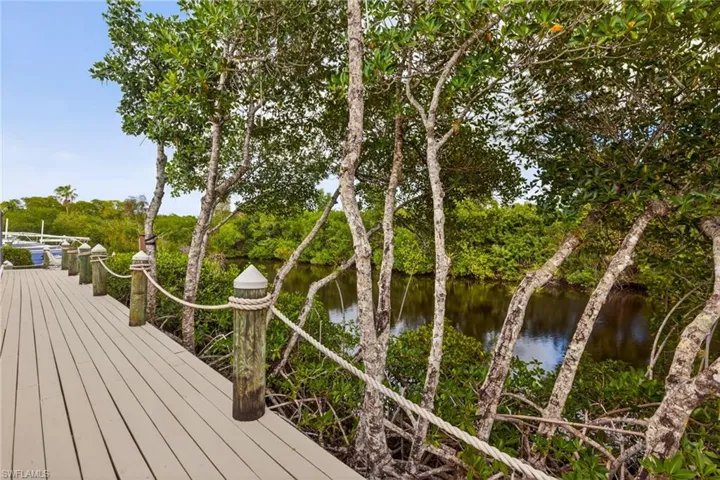 Wooden terrace with a water view and a boat dock