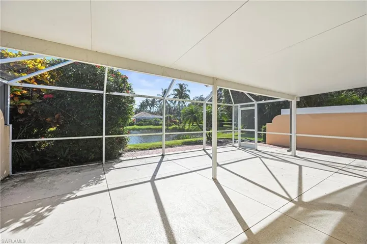 View of patio / terrace featuring glass enclosure, a sunroom, and a water view