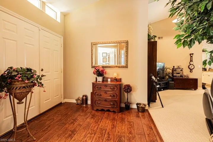 Entryway with dark wood finished floors and baseboards