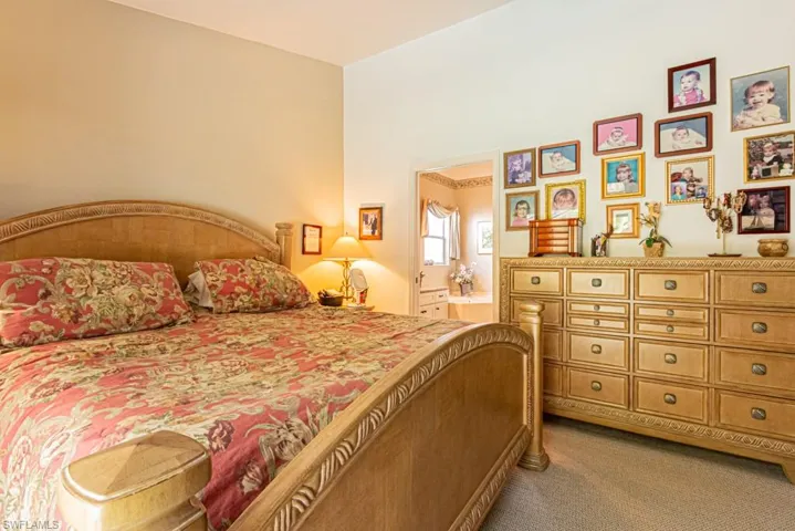 Bedroom featuring carpet flooring and ensuite bathroom