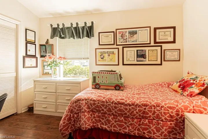 Bedroom featuring dark wood-style flooring and a closet