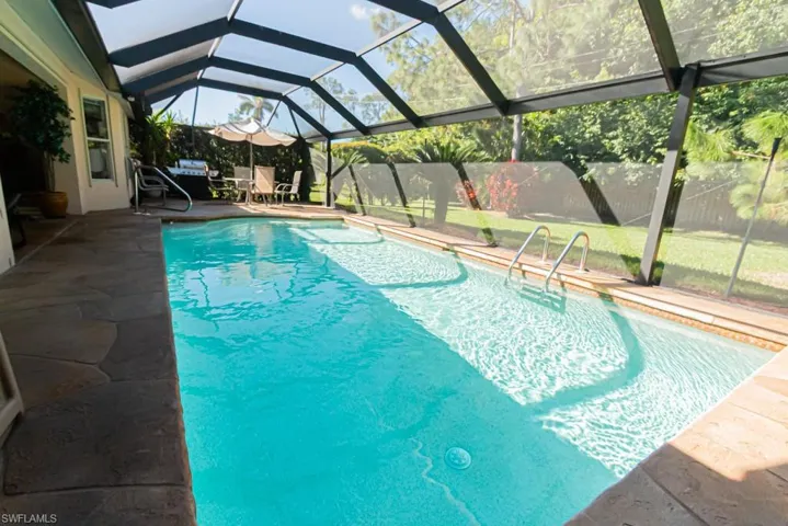 Swimming pool with a lanai, a patio area, and a sunroom