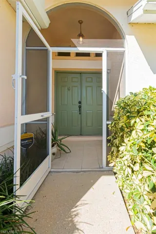 Entrance to property with stucco siding