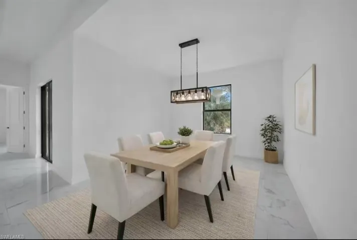 Dining room featuring light marble finish flooring