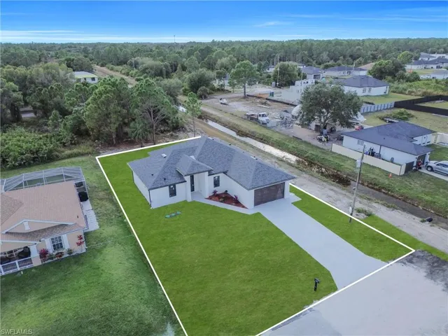 Aerial perspective of suburban area featuring property parcel outlined
