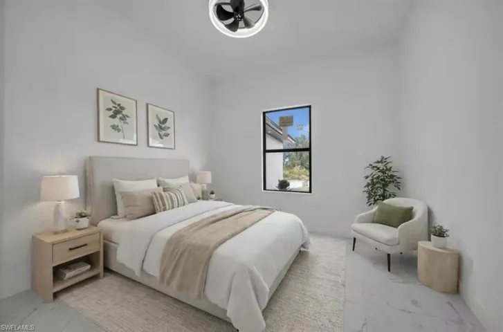 Bedroom featuring light marble finish floors