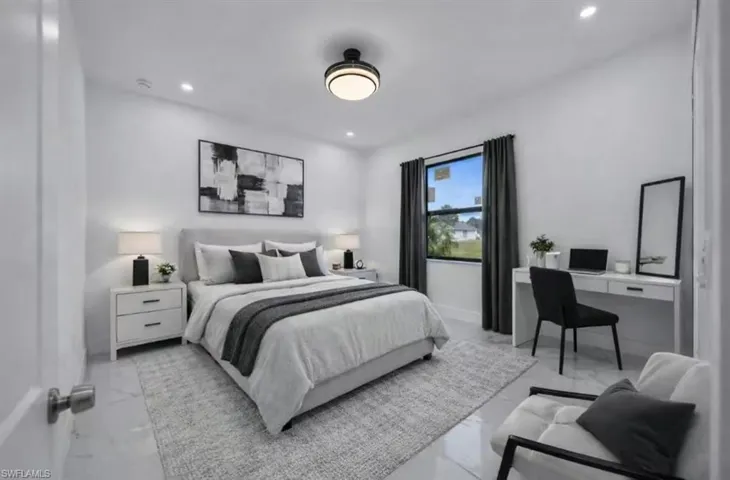 Bedroom featuring a desk, marble finish floors, and recessed lighting