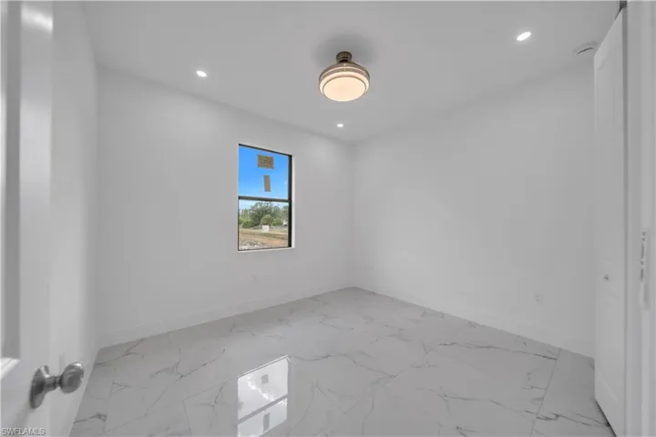Spare room with light marble finish flooring and recessed lighting