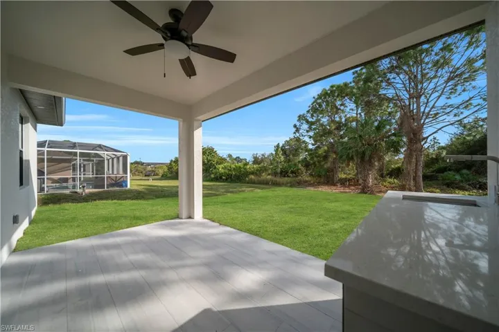 View of patio featuring a ceiling fan, a lanai, and a sunroom