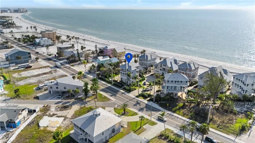 Aerial view featuring a view of the beach, a residential view, and a water view