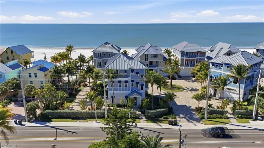 Aerial view of residential area with waterfront with a beach
