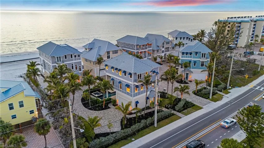 Aerial view at dusk with a water view and a residential view