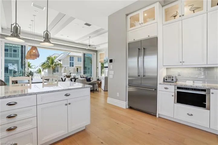 Kitchen featuring white cabinets and light stone counters