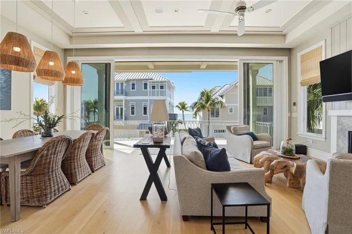 Living area with light wood-type flooring, plenty of natural light, and ceiling fan