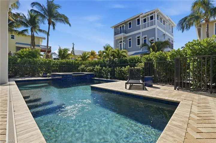 View of pool featuring a patio and a pool with connected hot tub