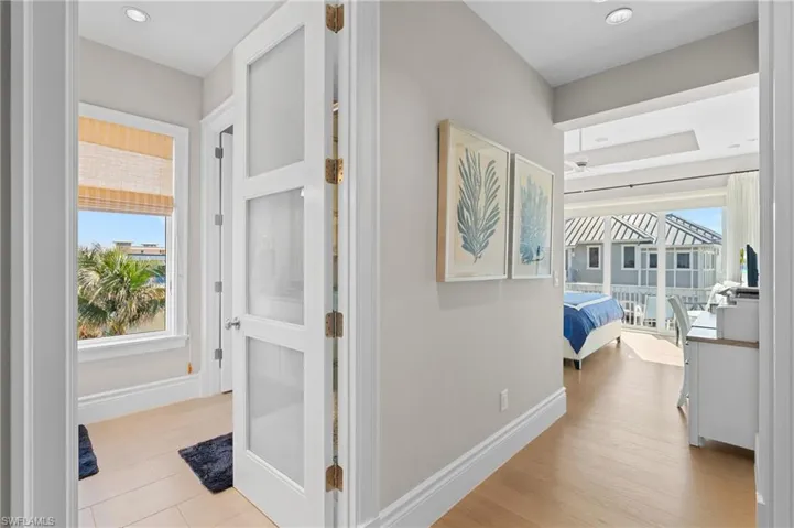 Corridor featuring baseboards, recessed lighting, and wood finished floors