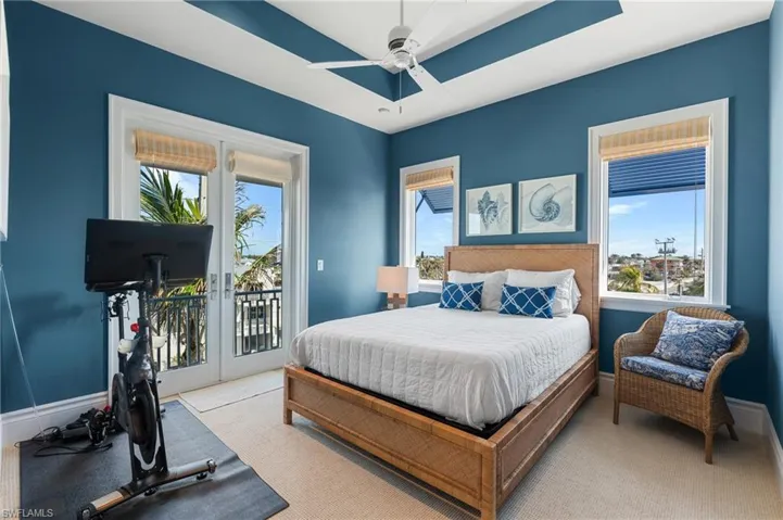 Carpeted bedroom with french doors, access to exterior, a ceiling fan, and baseboards