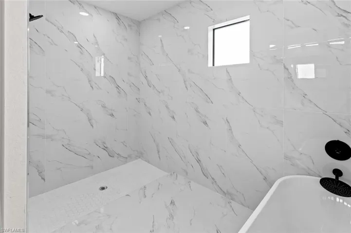 Room details featuring tiled shower