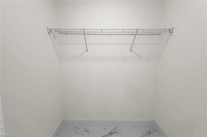 Spacious closet featuring tile floors