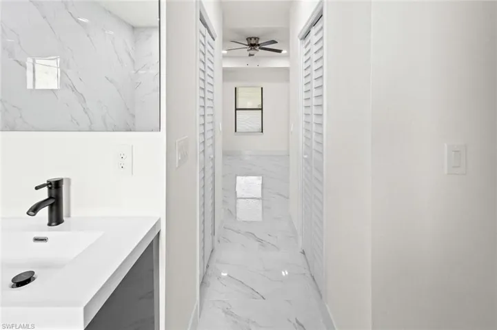 Bathroom featuring sink, tile flooring, and ceiling fan