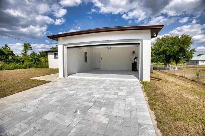 Garage featuring a lawn