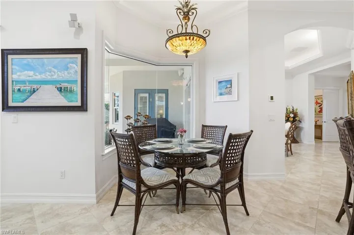 The eat in kitchen features a beautiful beveled glass window highlighting the natural light and private views