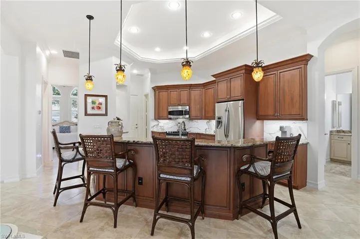 Counter dining under the pendant lights in this newly refreshed spacious kitchen