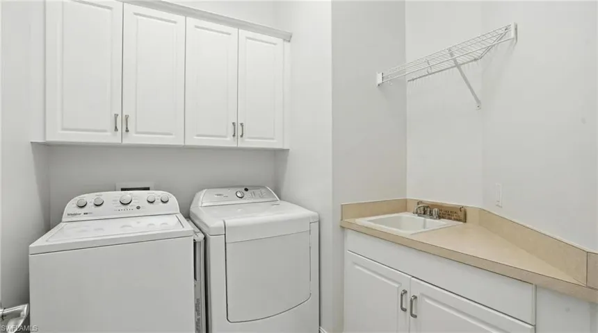 Laundry room with cabinet space and washing machine and dryer