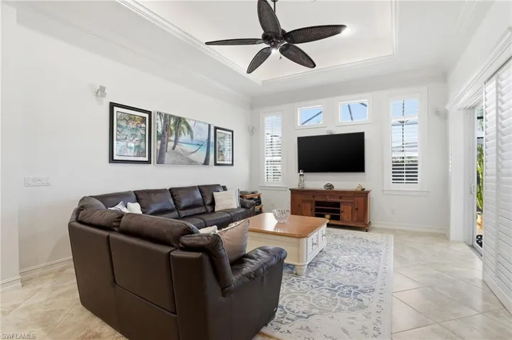 This family room is full of natural light, high ceilings and plantation shutters