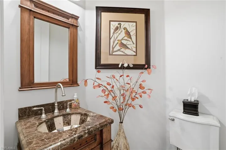Half bathroom featuring vanity and toilet