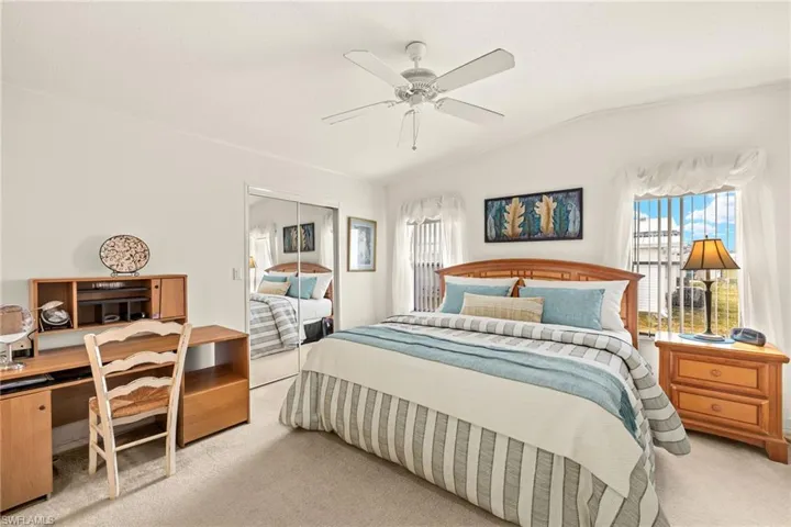 Bedroom with a ceiling fan, a closet, carpet flooring, and vaulted ceiling