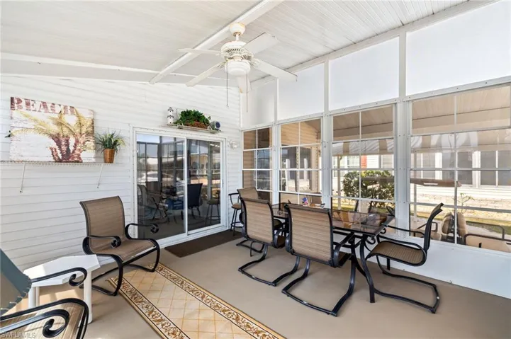 Sunroom / solarium featuring a ceiling fan