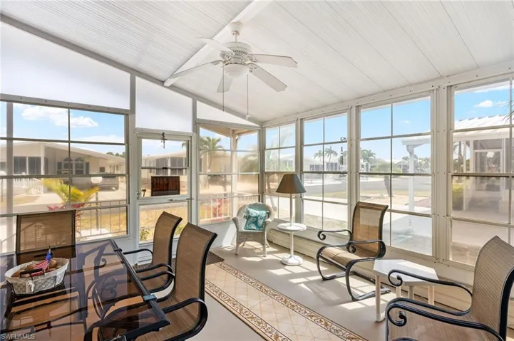 Sunroom / solarium featuring ceiling fan