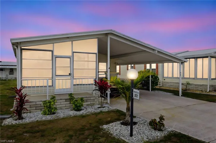 Manufactured / mobile home with a carport and concrete driveway