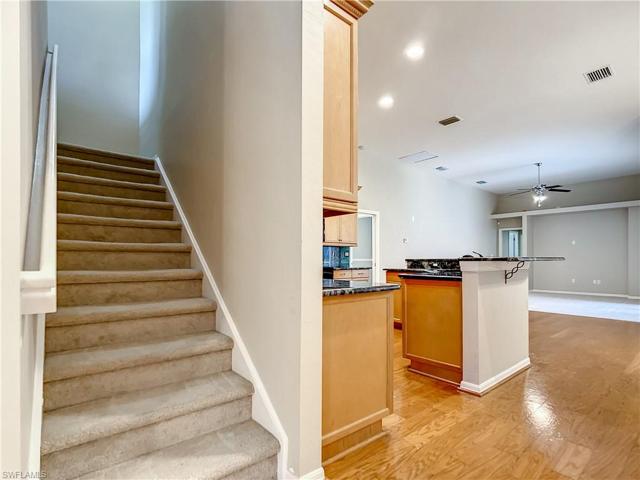 Stairs to large media/all purpose room with bath